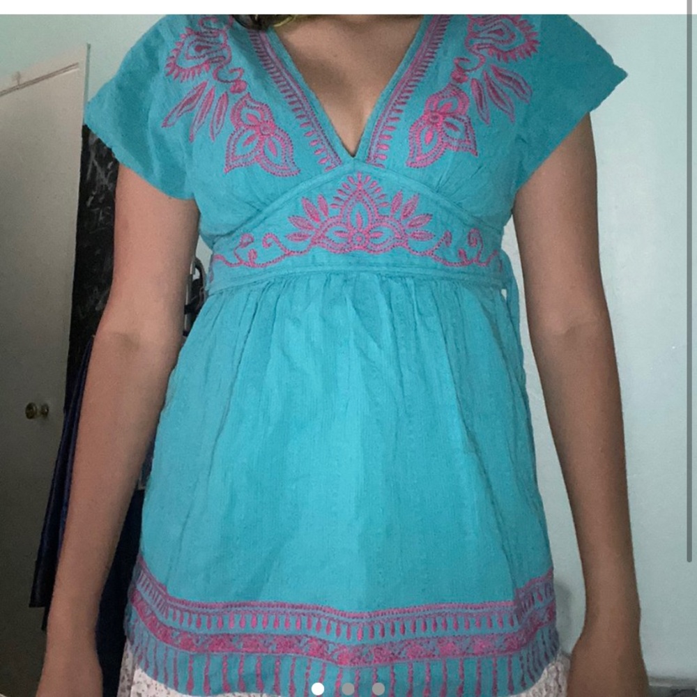 Super cute blue and pink peplum style top.